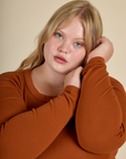 Close up of Juliet in the Burnt Terracotta Long Sleeve Baby Tee