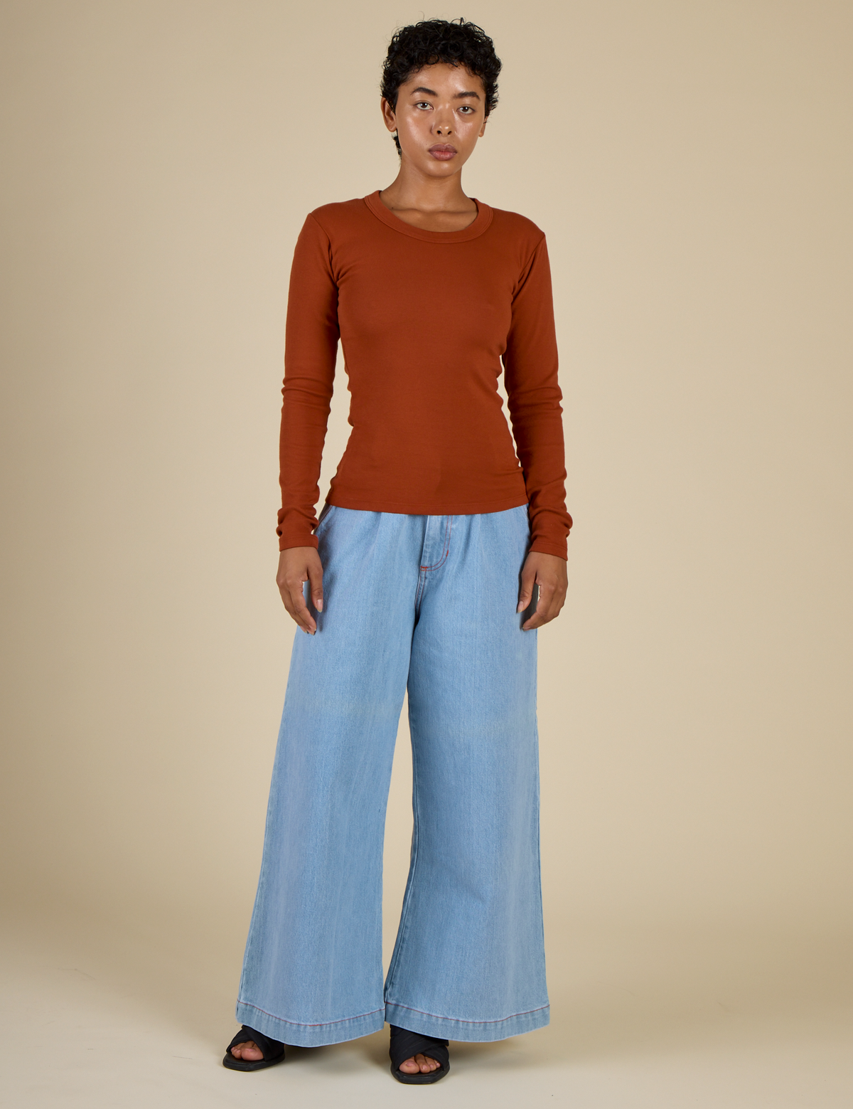 Mika in the Burnt Terracotta Long Sleeve Baby Tee and Petite Light Wash Wide Leg Denim Trousers