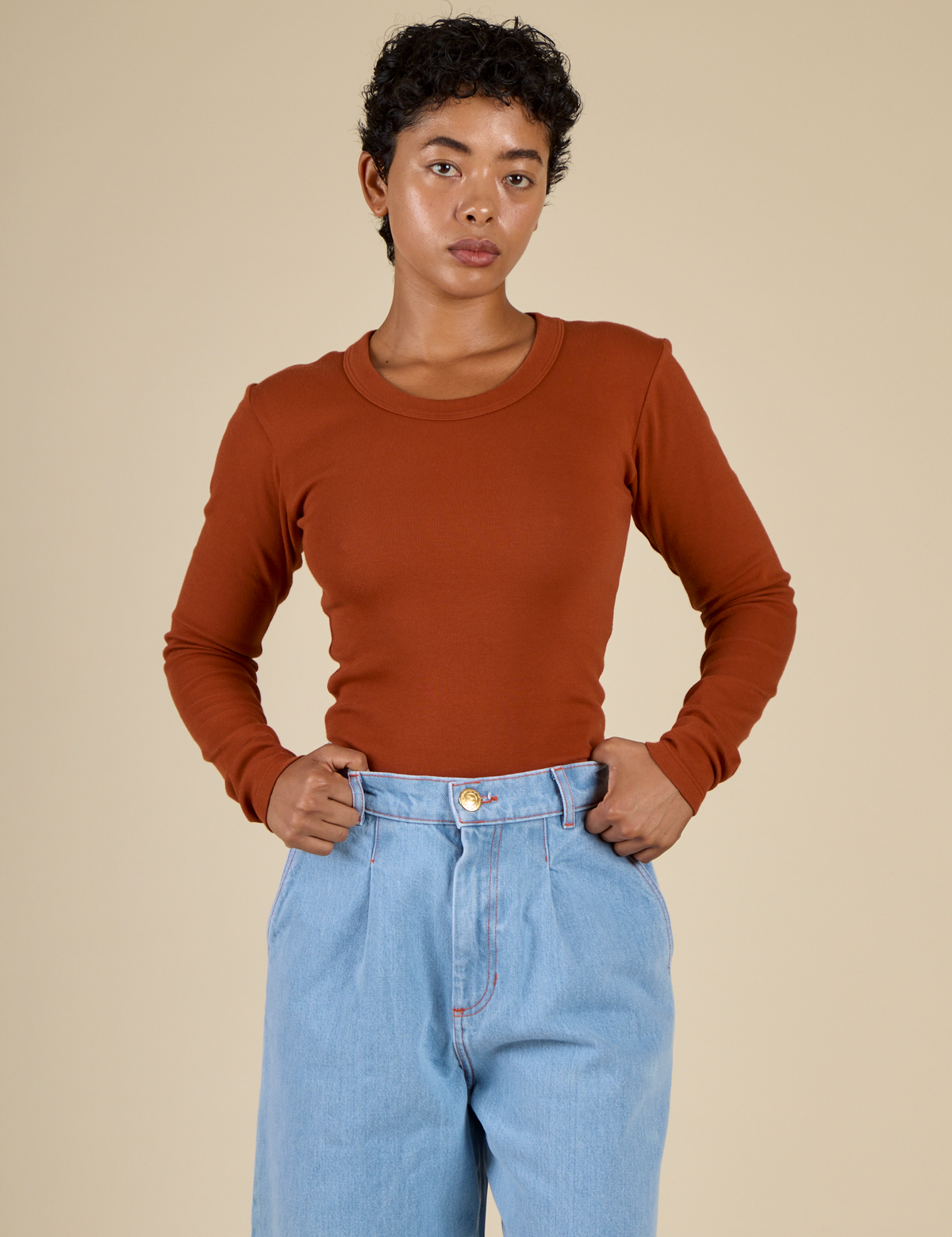 Mika wearing the Burnt Terracotta Long Sleeve Baby Tee tucked in
