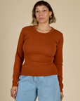 Tiara is 5'4" and wearing the Burnt Terracotta Long Sleeve Baby Tee