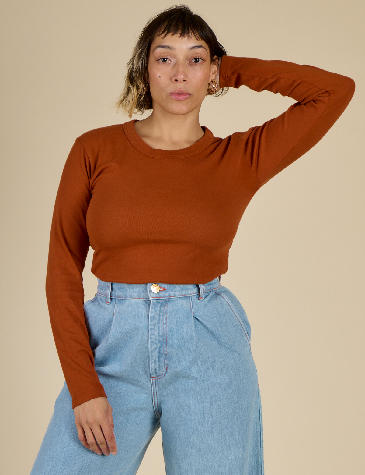 Tiara wearing the Burnt Terracotta Long Sleeve Baby Tee tucked in