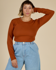 Tiara wearing the Burnt Terracotta Long Sleeve Baby Tee tucked in