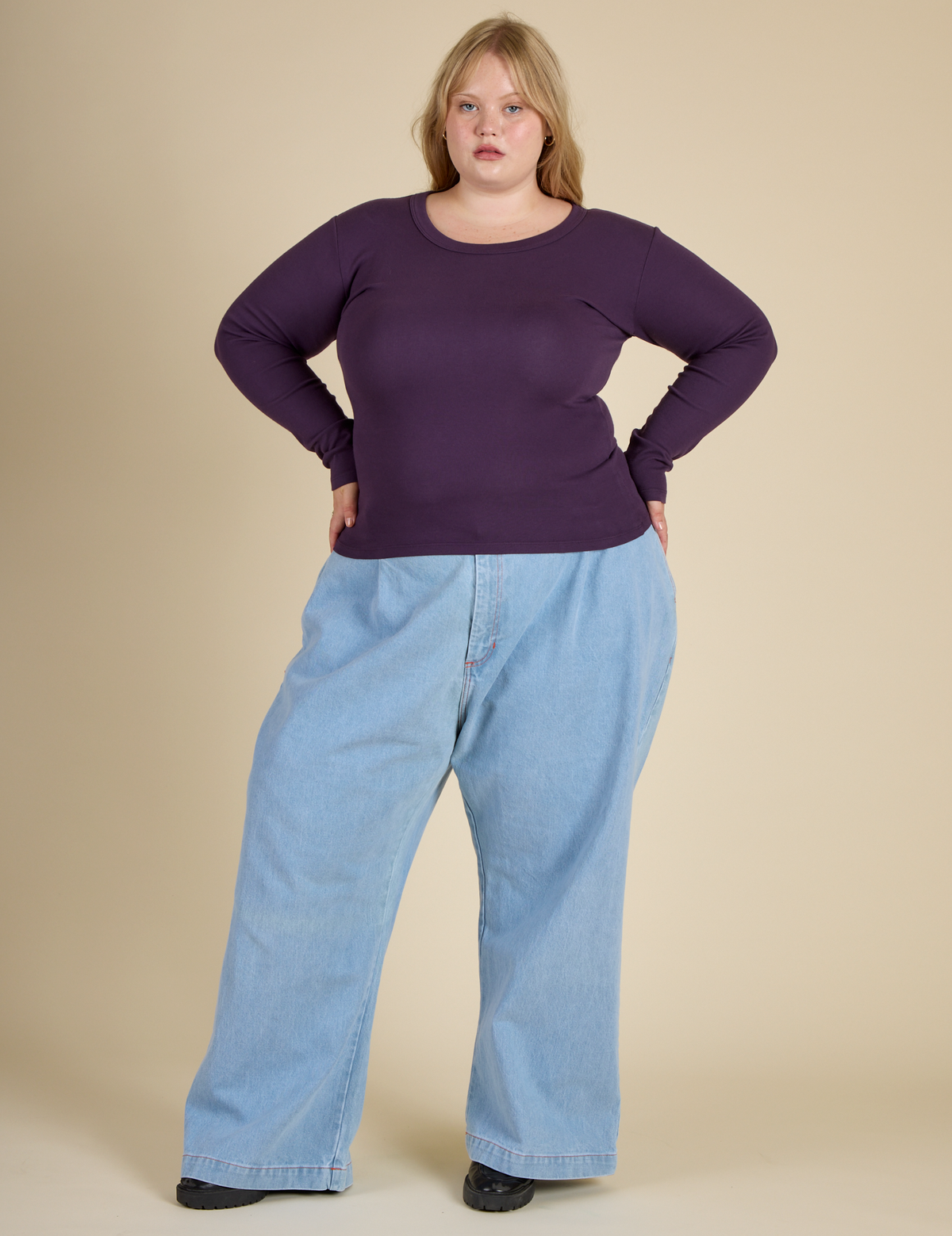Juliet is wearing the Nebula Long Sleeve Baby Tee with Light wash Denim Wide Led trousers
