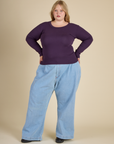 Juliet is wearing the Nebula Long Sleeve Baby Tee with Light wash Denim Wide Led trousers