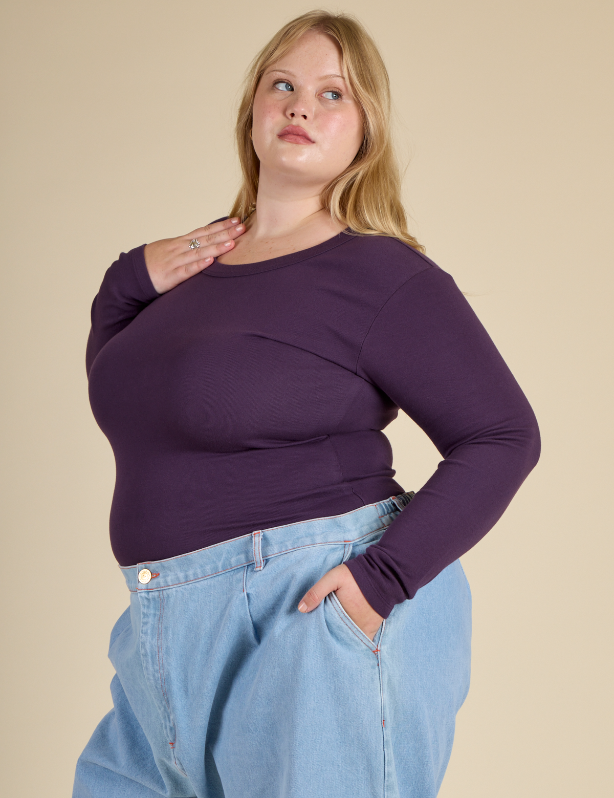 Angled side view of Juliet wearing the Nebula Long Sleeve Baby Tee