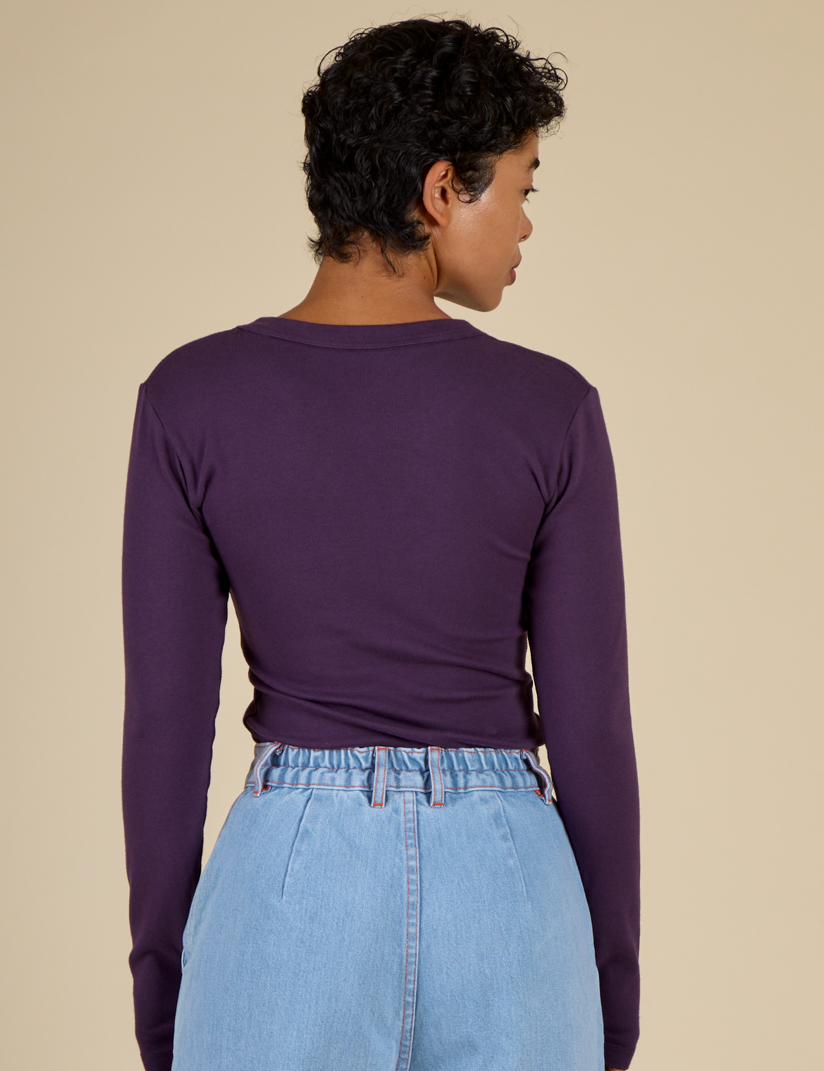Back view of the Nebula Long Sleeve Baby Tee on Mika