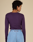 Back view of the Nebula Long Sleeve Baby Tee on Mika