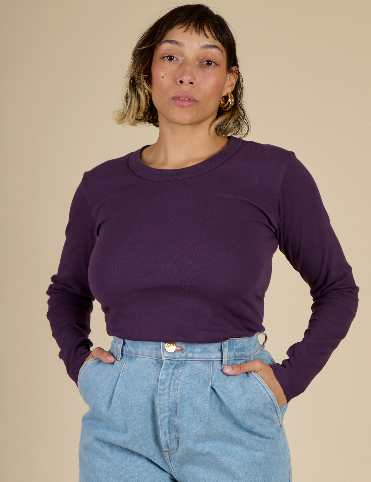 Tiara wearing the Nebula Long Sleeve Baby Tee tucked in