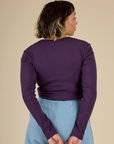 Back view of the Nebula Long Sleeve Baby Tee on Tiara