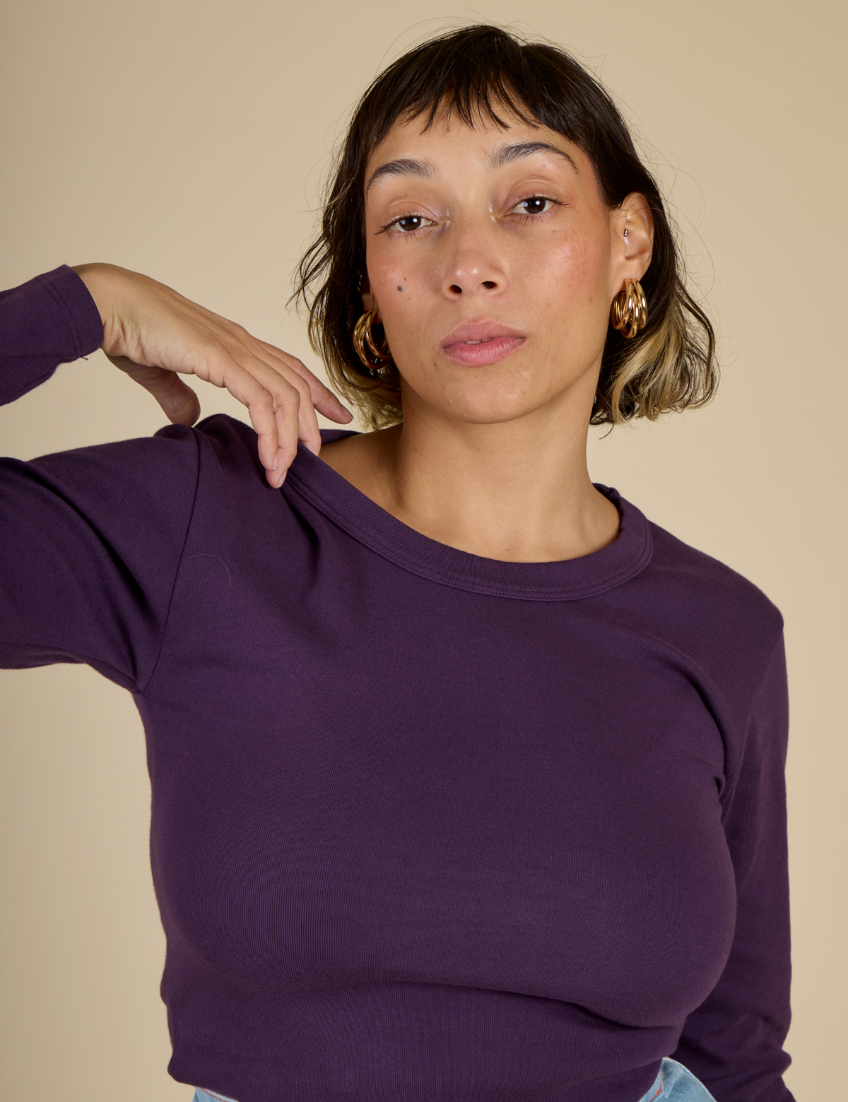 Close up on Tiara wearing the Nebula Long Sleeve Baby Tee