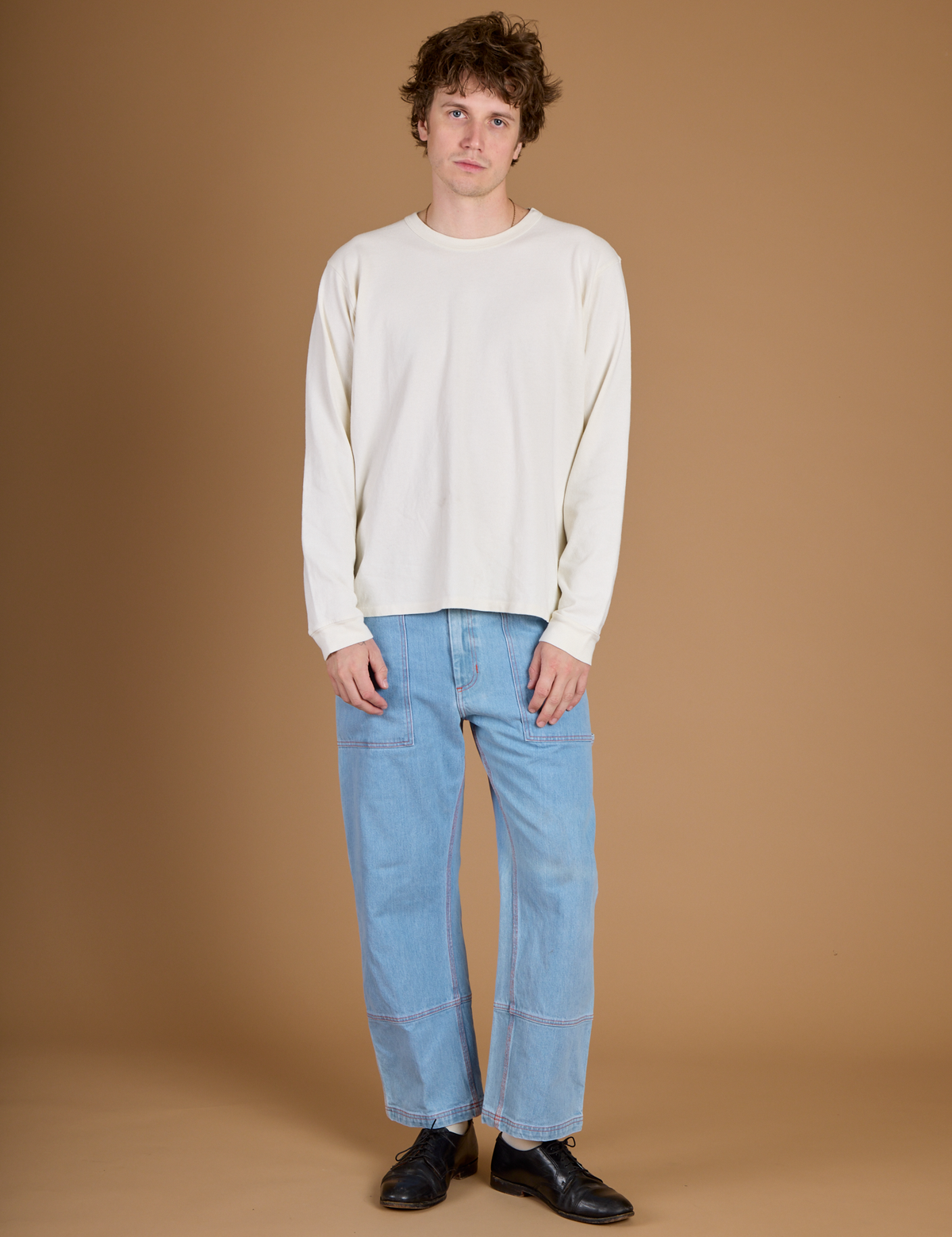 Quinn wearing the Vintage Tee White Long Sleeve Burly Tee with Light Wash Carpenter Jeans