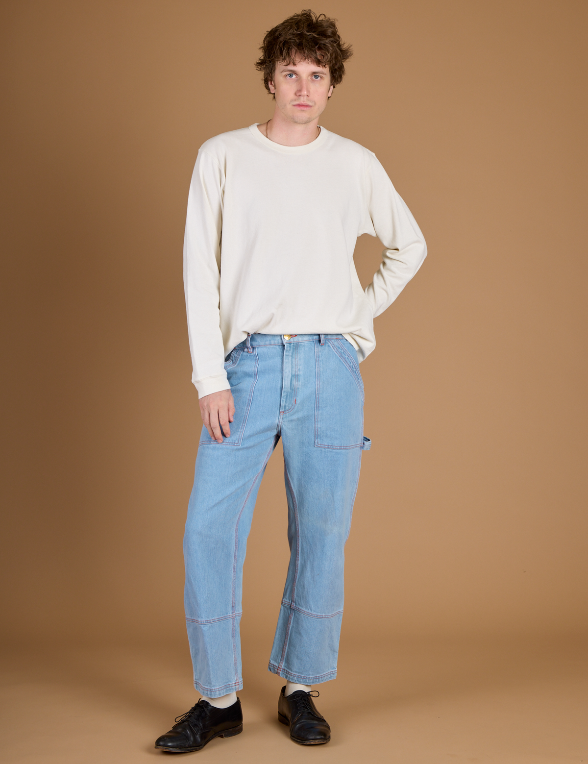 Quinn Wearing the Vintage Tee White Long Sleeve Burly Tee tucked into the Light Wash Carpenter Jeans