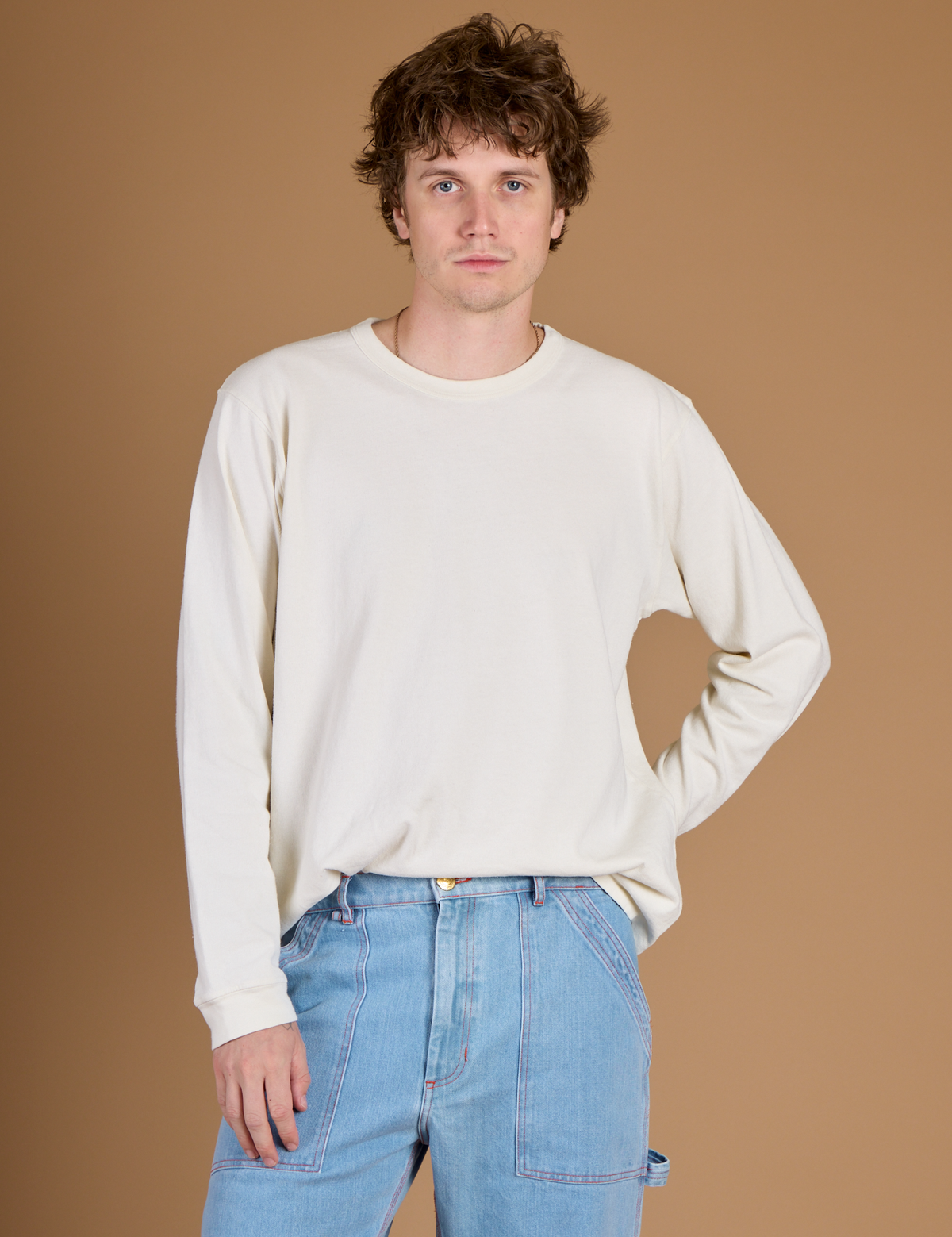 Quinn wearing the Vintage Tee White Long Sleeve Burly Tee tucked in
