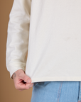 Close up of the hem on the Vintage Tee White Long Sleeve Burly Tee worn by Quinn