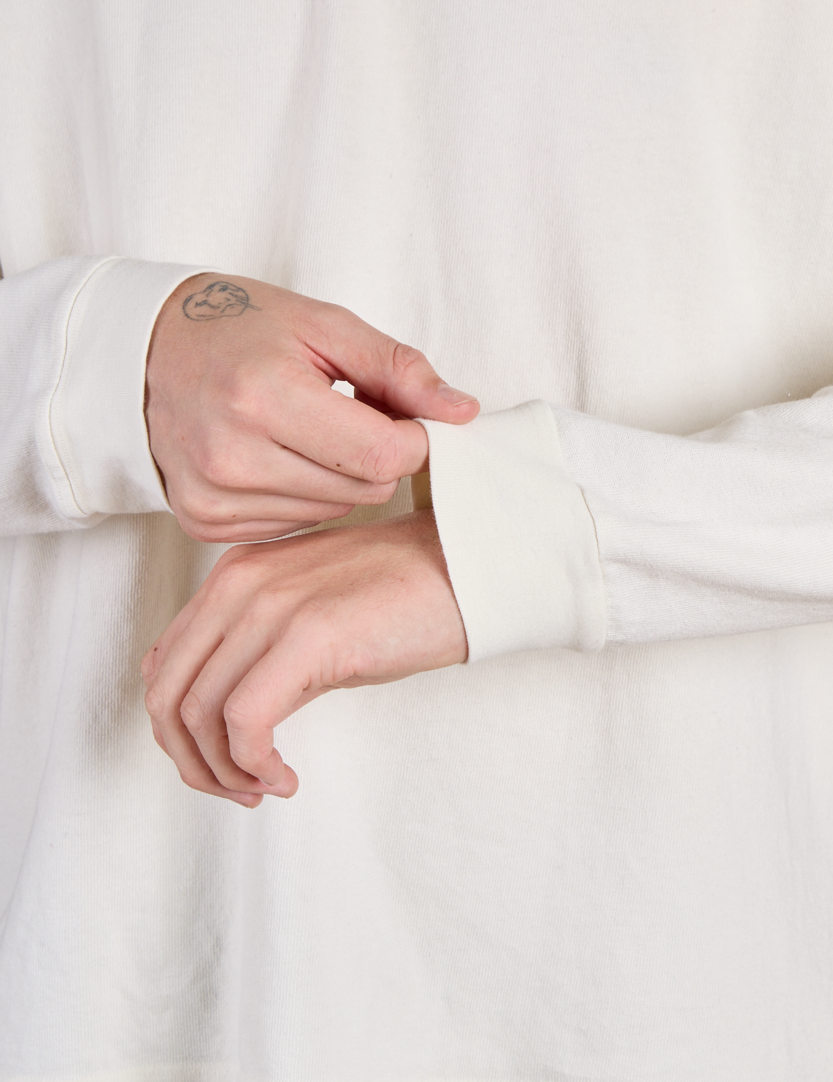 Close up of the Vintage Tee White Long Sleeve Burly Tee's sleeves worn by Quinn