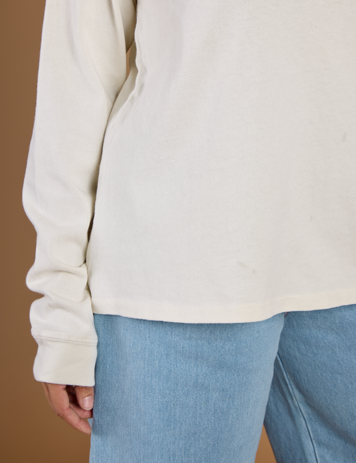 Close up of the hem on the Vintage Tee White Long Sleeve Burly Tee worn by Tiara