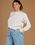 Angled side view of Tiara wearing the Vintage Tee White Long Sleeve Burly Tee 