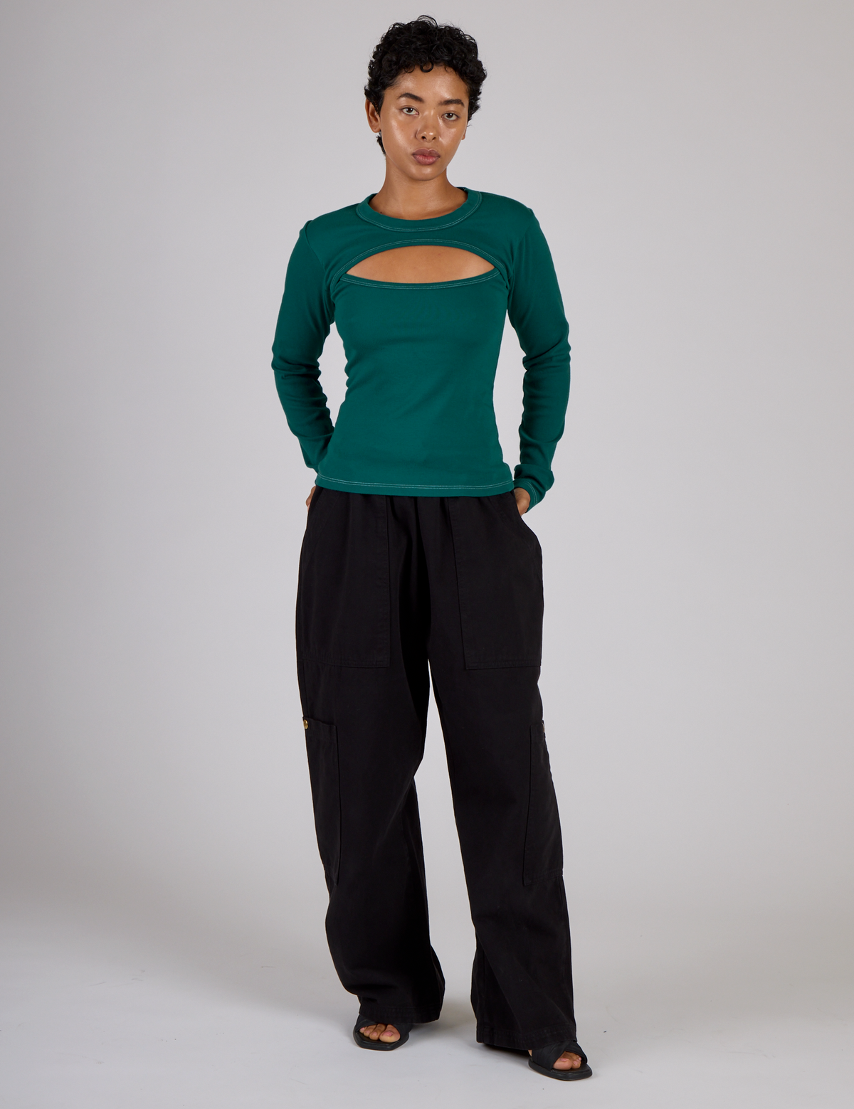 Mika wearing the Hunter Green Long Sleeve Porthole Tee with Black Drop Pocket Pants