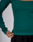 Close up of the hem on the Hunter Green Long Sleeve Porthole Tee