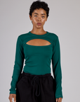 Mika wearing the Hunter Green Long Sleeve Porthole Tee tucked in