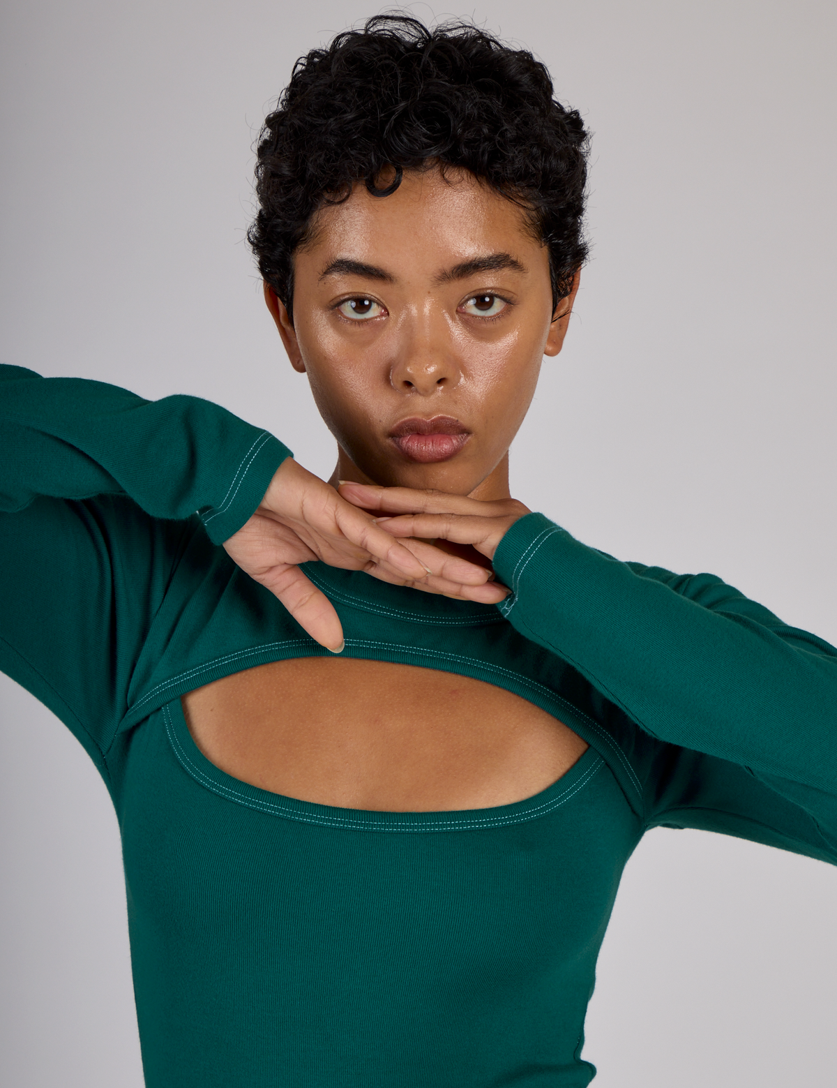 Close up of Mika in the Hunter Green Long Sleeve Porthole Tee