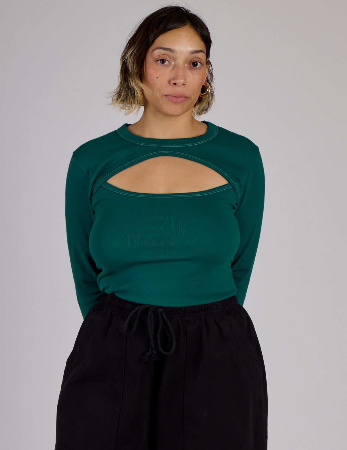 Tiara is wearing the Hunter Green Long Sleeve Porthole Tee tucked in
