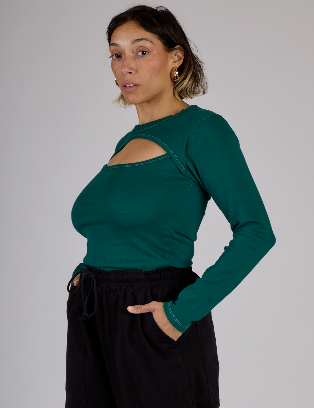 Tiara wearing the Hunter Green Long Sleeve Porthole Tee tucked into Black Drop Pocket Pants