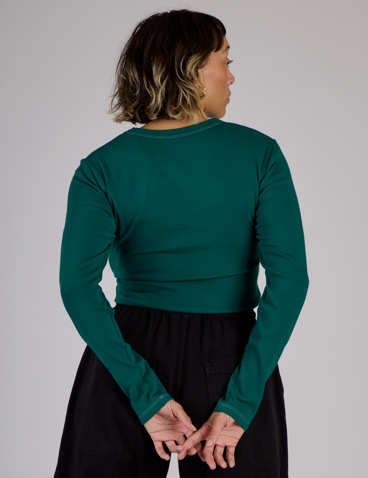 Back view of Tiara in the Hunter Green Long Sleeve Porthole Tee