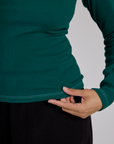 Close up of the hem on the Hunter Green Long Sleeve Porthole Tee worn by Tiara