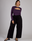 Tiara wearing the Nebula Purple Long Sleeve Porthole Tee tucked into the Black Drop Pocket Pants