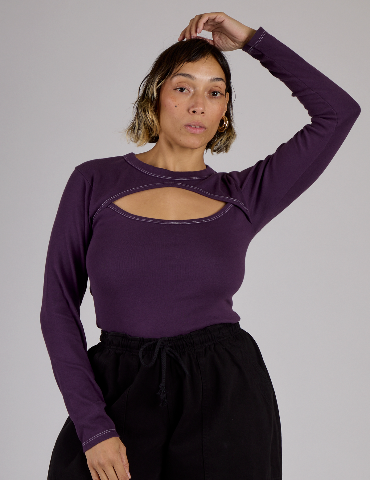 Tiara wearing the Nebula Purple Long Sleeve Porthole Tee tucked in