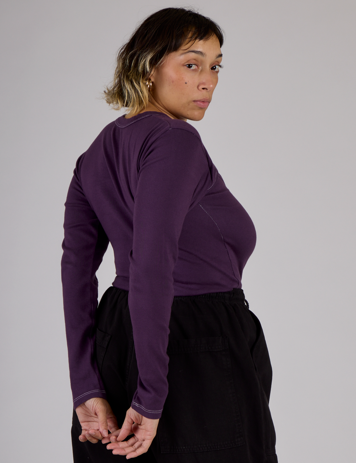 Angled back view of the Nebula Purple Long Sleeve Porthole Tee on Tiara