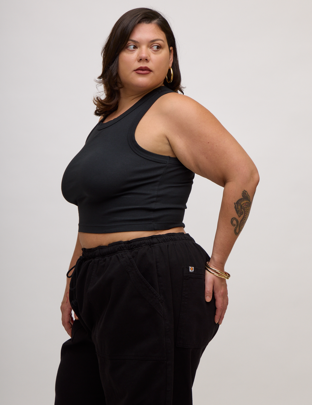 Angled side view of the Basic Black Deep Cut Racerback  on Kristen