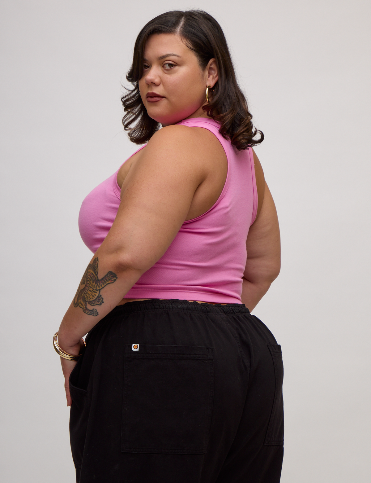 Angled back view of Kristen in the P Bubblegum Pink Deep Cut Racerback