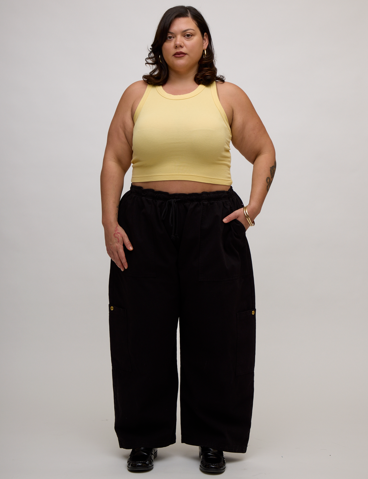 Kristen is wearing the Butter Yellow Deep Cut Racerback with Black Drop Pocket Pants