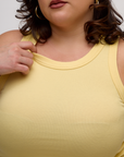 Close up of the Butter Yellow Deep Cut Racerback's neckline worn by Kristen