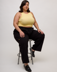 Kristen wearing the Butter Yellow Deep Cut Racerback with Black Drop Pocket Cargo Pants