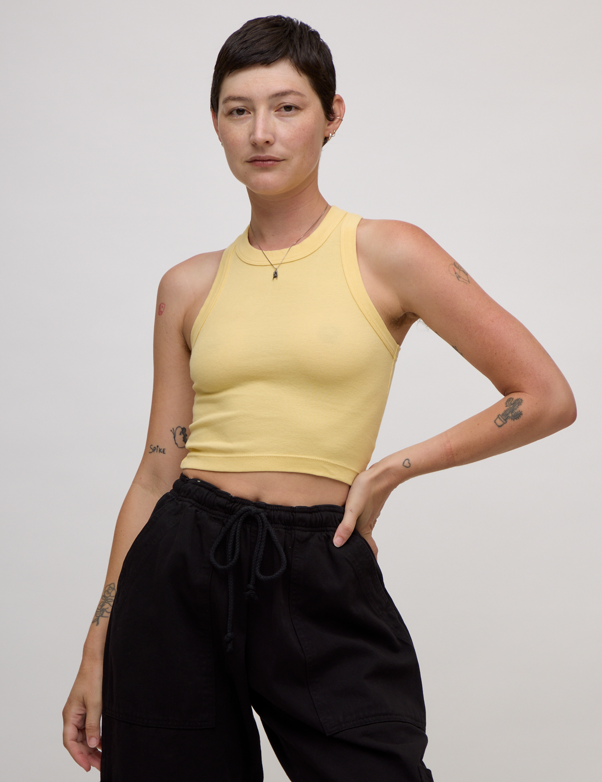 Alex is 5'8" and wearing P Butter Yellow Deep Cut Racerback