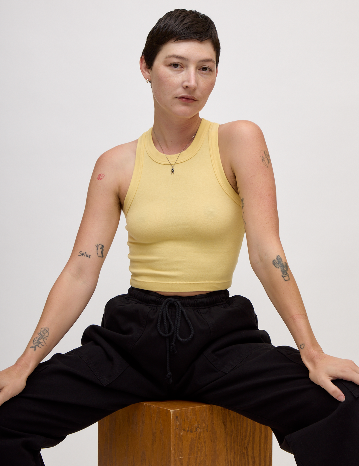 Alex wearing the Butter Yellow Deep Cut Racerback
