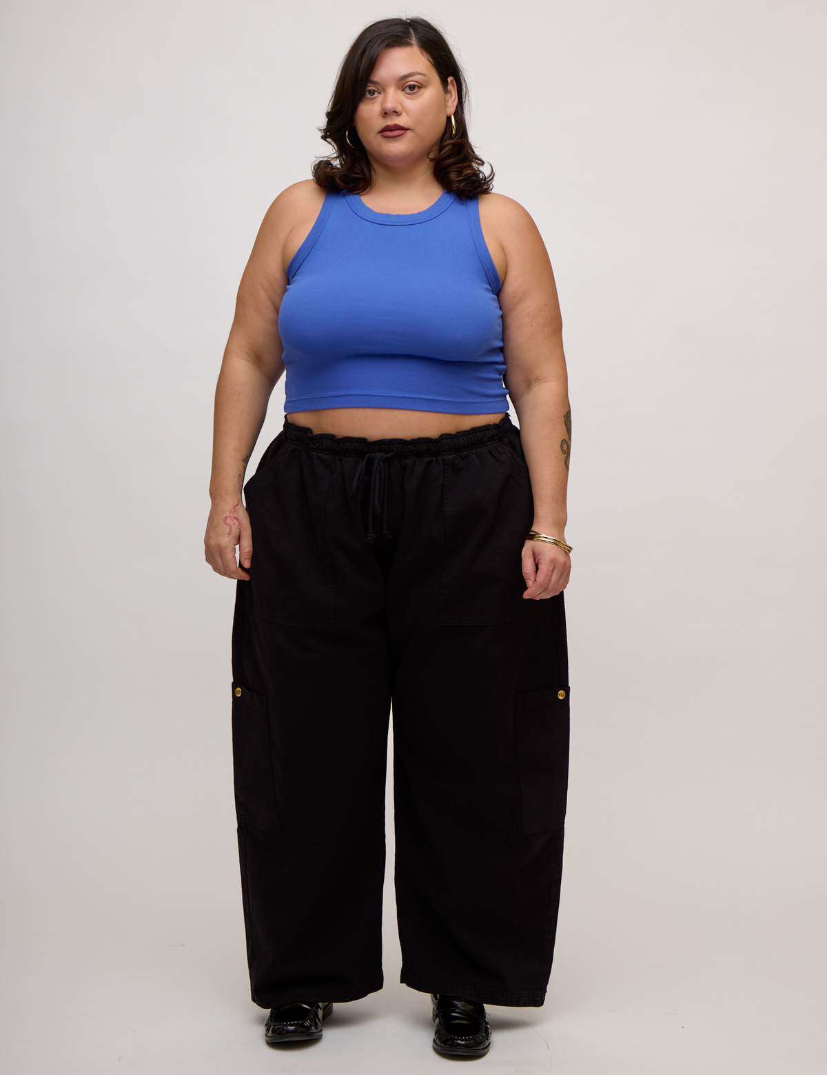 Kristen is wearing the Cornflower Blue Deep Cut Racerback with Black Drop Pocket Pants