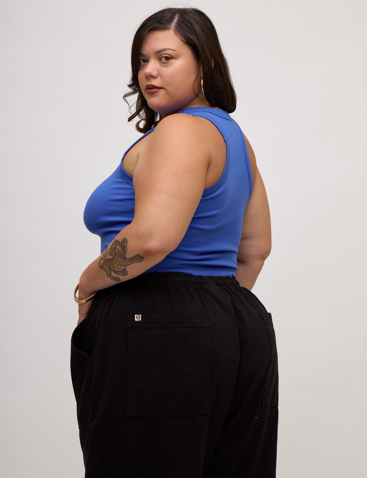 Angled back view of Kristen in the Cornflower Blue Deep Cut Racerback