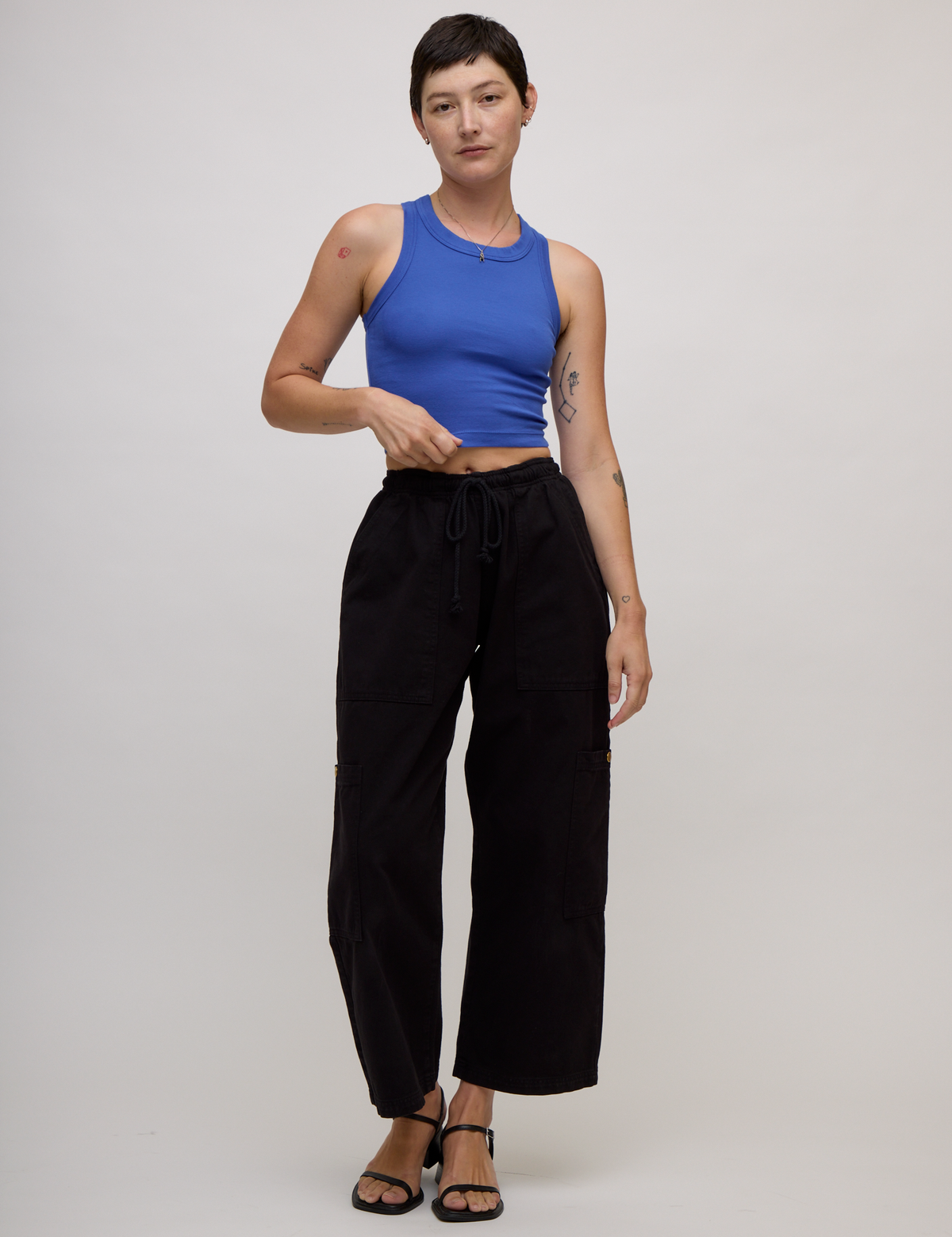 Alex is 5'8" and wearing P Cornflower Blue Deep Cut Racerback with Black Drop Pocket Pants