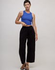 Alex is 5'8" and wearing P Cornflower Blue Deep Cut Racerback with Black Drop Pocket Pants