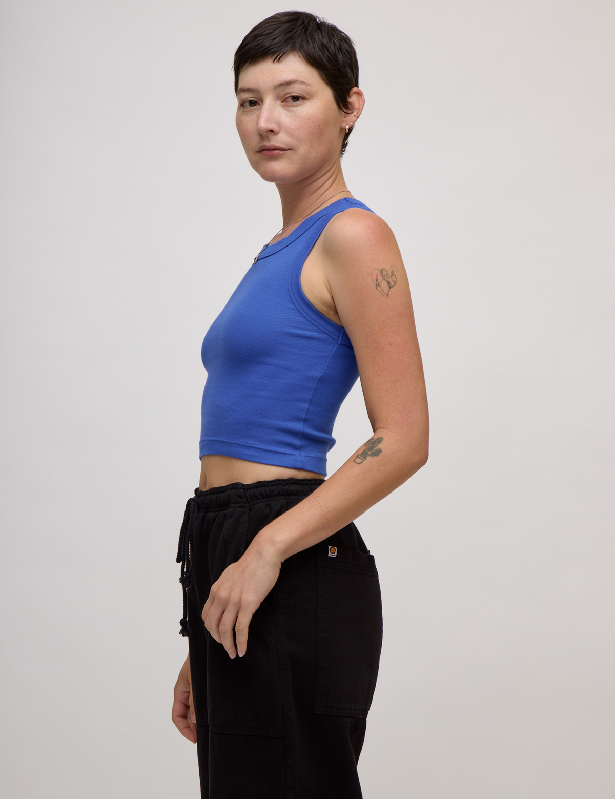 Side view of Alex in the Cornflower Blue Deep Cut Racerback