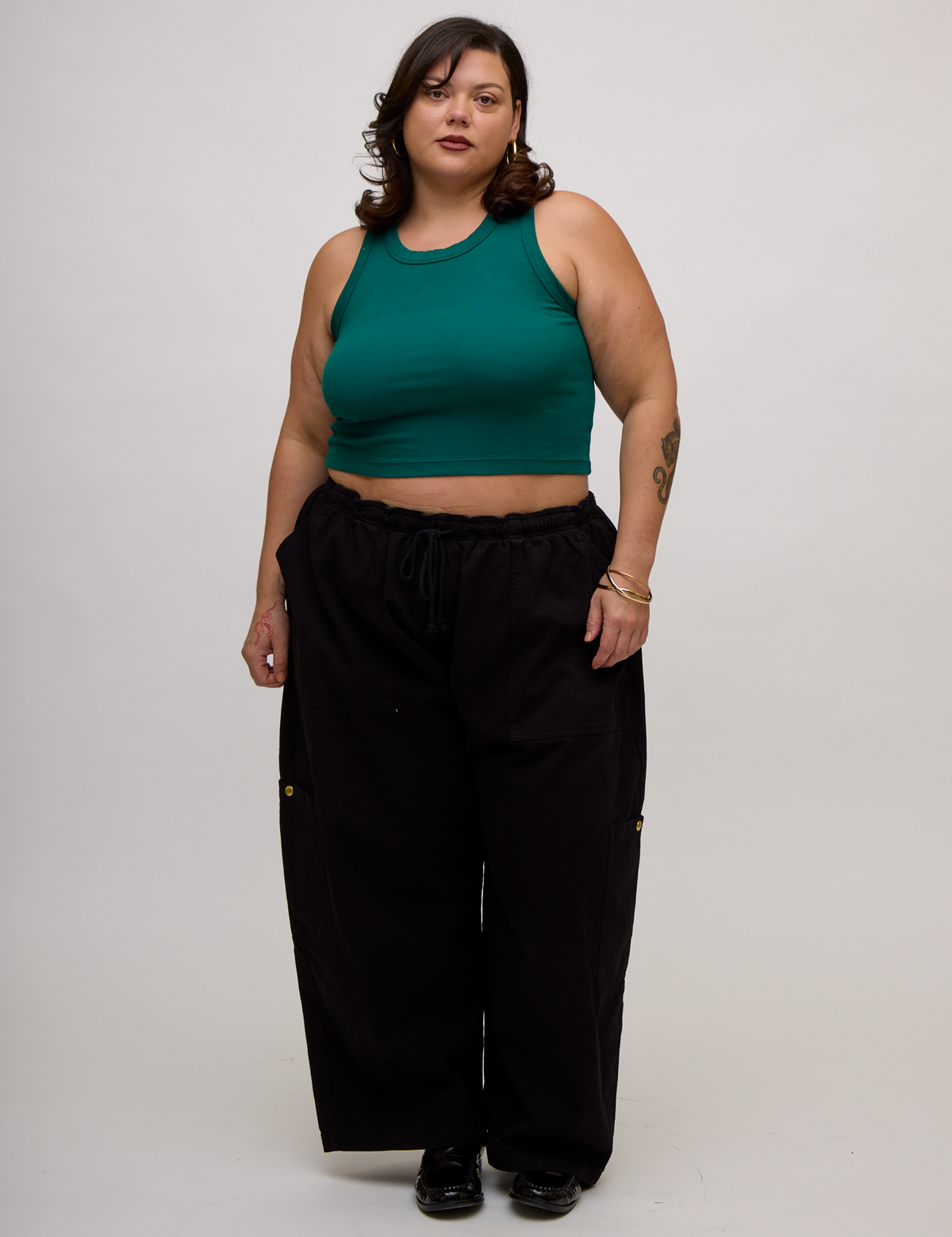 Kristen is 5'9" and wearing L Hunter Green Deep Cut Racerback with Black Drop Pocket Pants
