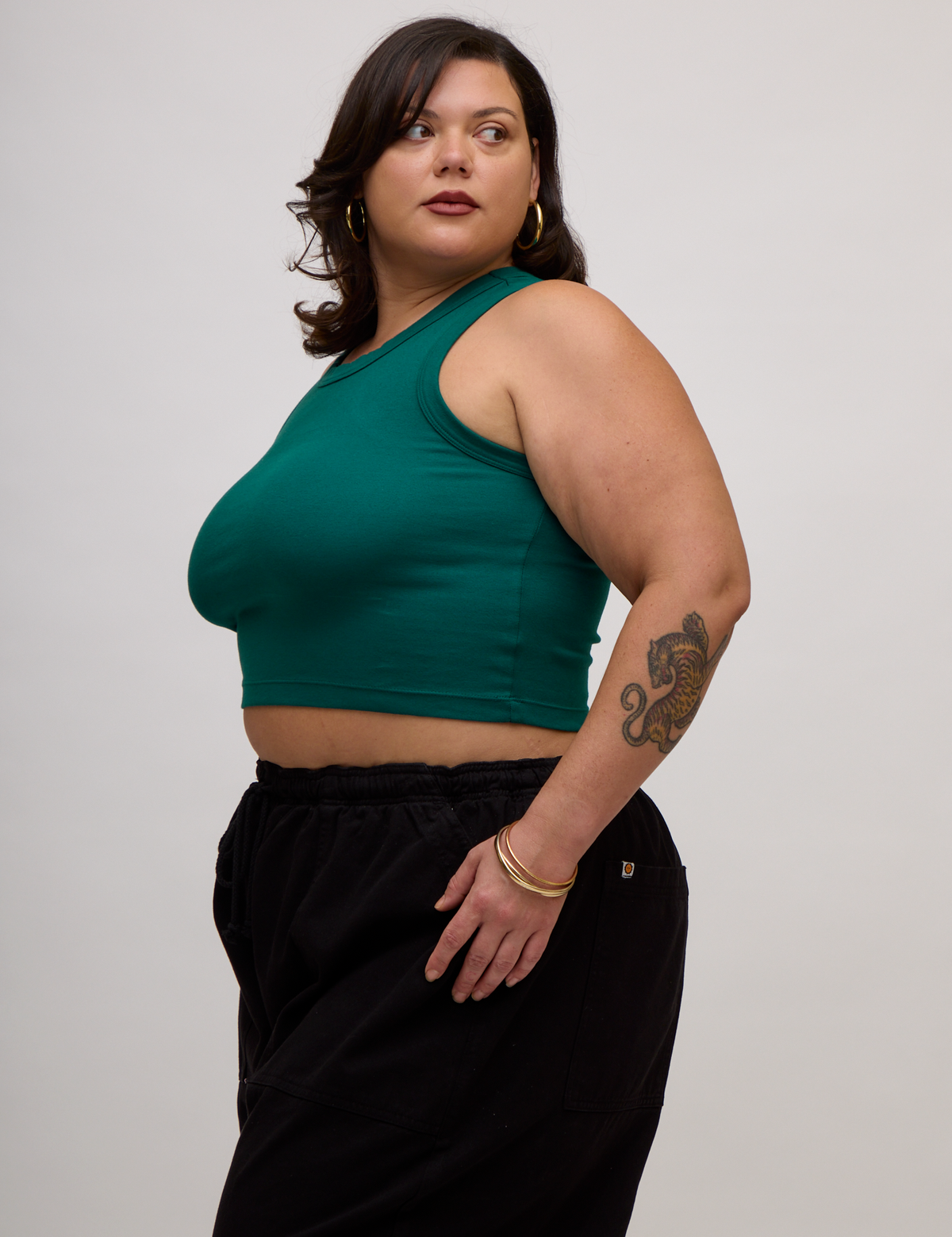 Angled side view of the Hunter Green Deep Cut Racerback on Kristen