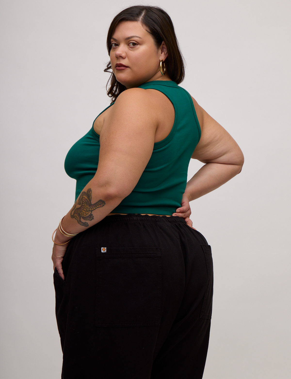 Angled back view of the Hunter Green Deep Cut Racerback on Kristen