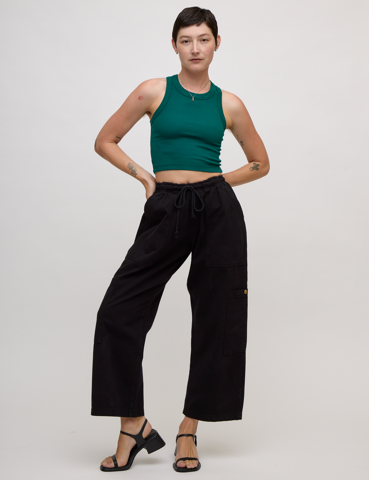 Alex wearing the Hunter Green Deep Cut Racerback and Black Drop Pocket Pants