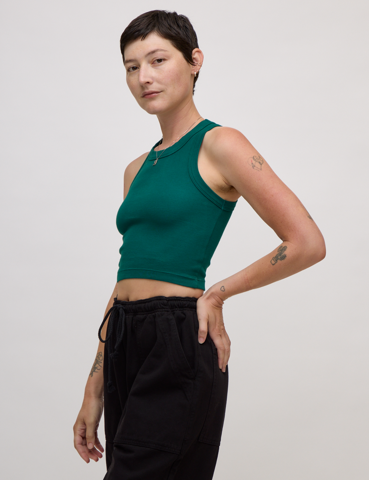 Side view of Alex in the Hunter Green Deep Cut Racerback