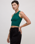 Side view of Alex in the Hunter Green Deep Cut Racerback